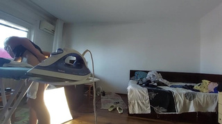 Homemade mom does chores in the naked house.